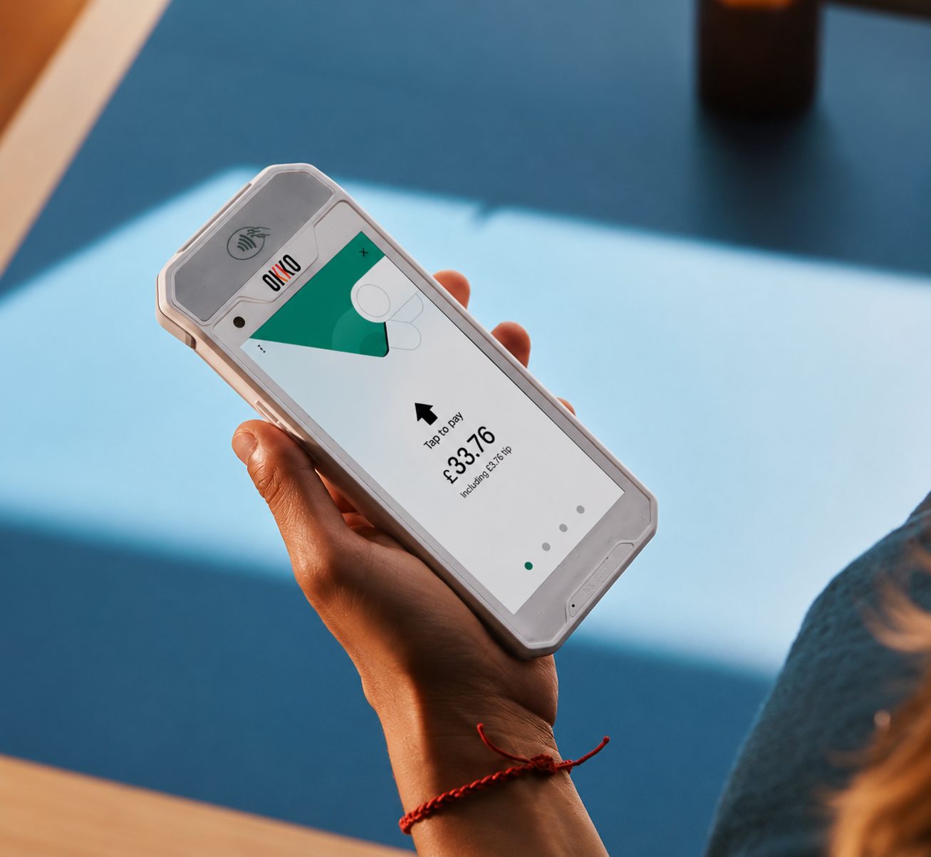 Taking a contactless payment on an OKKO handheld at a mobile food business